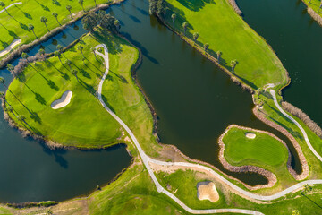 The Ultimate Retirement Dream: Cinematic Aerial Flyover of Salgados Golf Course Nestled Between the Atlantic Ocean and Natural Lagoons in Algarve, Portugal