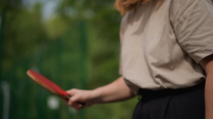 Teen Girl Preparing For Table Tennis Game, Female Teenager Focusing On Paddle Technique Outdoors, Young Woman Diligently Practicing Her Racket Hold In Open Air Table Tennis Setting