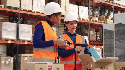 Warehouse workers scanning and checking inventory together - Powered by Adobe