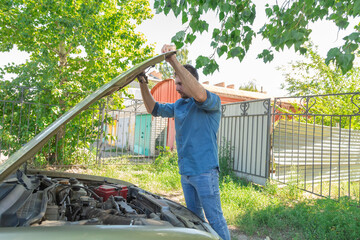 Man check broken car and open bonnet outdoor