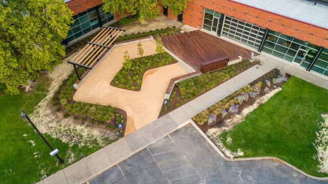 Aerial view of a tranquil outdoor space, where a winding path of light gravel meets the warm tones of wooden decking, Apollo Park, Hillsboro, Oregon, United States.
