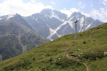 Naklejka premium Cheget mountain landscape with a ski lift tower and green slope