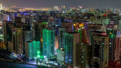 Naklejka premium Aerial skyline of Abu Dhabi city centre from above night timelapse