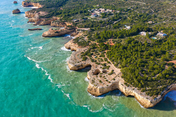 Algarve's Hidden Jewel: Cinematic Aerial View of Praia de Albandeira and its Iconic Sea Arch, Nestled Along the Rugged Coastal Hiking Trails of Portugal