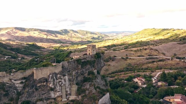 Roccascalegna fortress on rocky peak with sweeping views of mountains and countryside.
