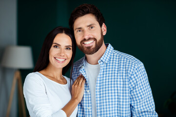 Fototapeta premium Romantic indoor couple portrait in living room, celebrating love and happiness together in a cozy home setting