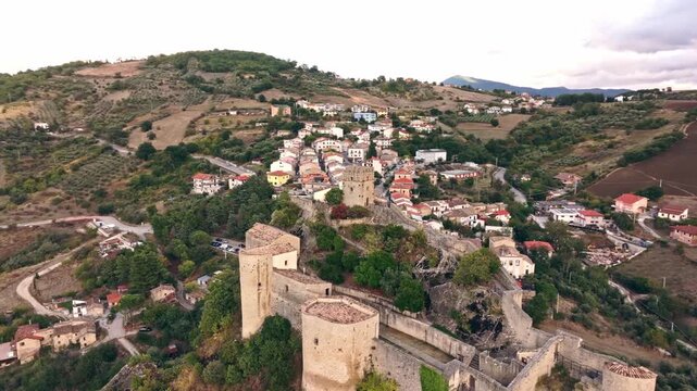 Aerial panorama of Roccascalegna fortress, historic town and mountainous Abruzzo landscape.
