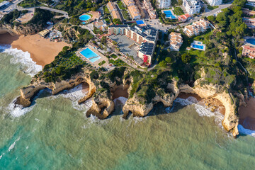 The Golden Coast: Aerial Cinematic 4K View of Luxury Villas, Resorts, and Real Estate at Alporchinhos Overlooking the Turquoise Waters of Praia de Albandeira, Algarve, Portugal