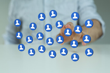 Hand touching digital network icons, representing connection, communication, social media, and global networkin