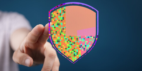 Concept of cybersecurity represented by a hand touching a pixelated shield, symbolizing protection and digital safety in the online w
