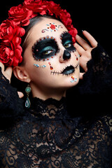 Halloween beauty portrait of woman. Beautiful female face adorned with Santa Muerte makeup.