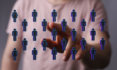 Abstract image showing a hand pointing at a group of digital human icons, emphasizing connection and the digita