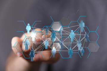 Hand touching network of people icons, representing social connections, and community, with modern abstract gra © vegefox.com