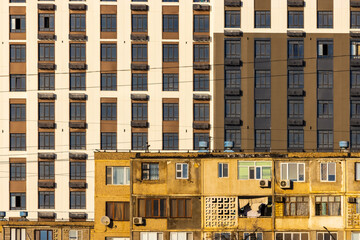 View of contrasting architecture, where modern buildings loom above aged structures, creating a striking juxtaposition of eras and styles, Aktau, Mangystau Region, Kazakhstan.