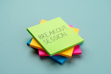 A stack of colorful sticky notes with text BREAKOUT SESSION. Meetings, conferences, workshops, brainstorming concept.