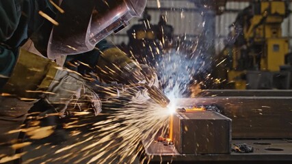 Welder wearing protective helmet and glove sparks fly as welding torch fuses metal beam industrial workshop with steel fabrication, glove and helmet protecting against bright spark and blue smoke - Powered by Adobe
