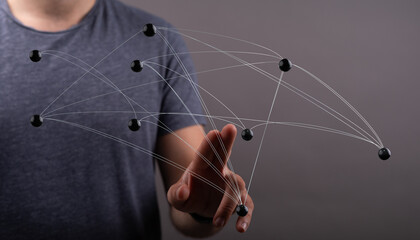 Person points at digital network with connected nodes symbolizing connection communication innovation.