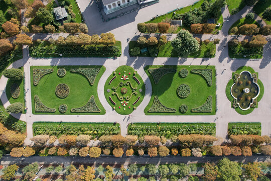 Aerial view of manicured gardens with symmetrical patterns and vibrant green lawns creating a stunning geometric display, Vienna, Austria.