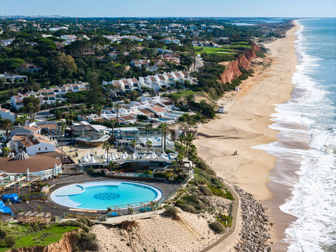 Luxury Living in the Golden Triangle: Cinematic 4K Aerial of Vale do Lobo Royal Golf Course and the Iconic Crimson Cliffs of Praia do Trafal, Algarve, Portugal