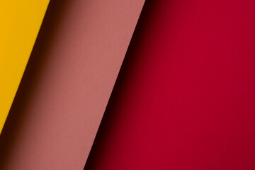 Bright colors create a pattern with yellow, brown, and red paper layered together in a modern design