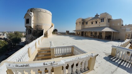 Exterior Architectural Detail of a Rajputana Fort Terrace Featuring a Cylindrical Staircase Tower and Heritage Design in Rajasthan, India 