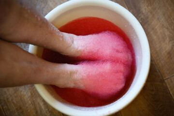 Relaxing foot spa treatment with pink gel.
