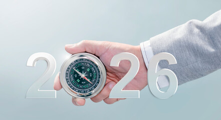 Businessman with compass navigator in the new year 2026. planning for success business. Consultant on market research, strategy and planning. Leadership and goals for success.