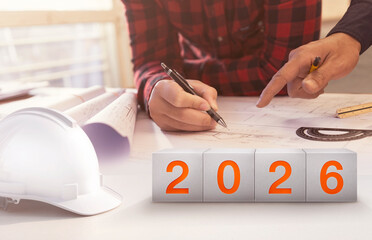 An engineer or architect is planning construction projects for the year 2026. The concept is related to construction and industry. 