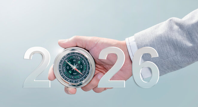 Businessman with compass navigator in the new year 2026. planning for success business. Consultant on market research, strategy and planning. Leadership and goals for success.