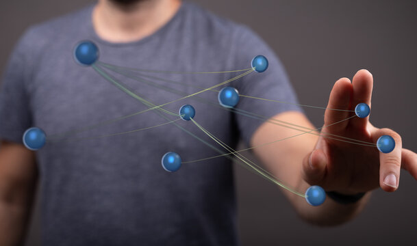 Close up of a hand interacting with a network of spheres representing connectivity, technology, and global conc - Powered by Adobe