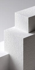 Abstract architectural detail with textured white surfaces and shadows.