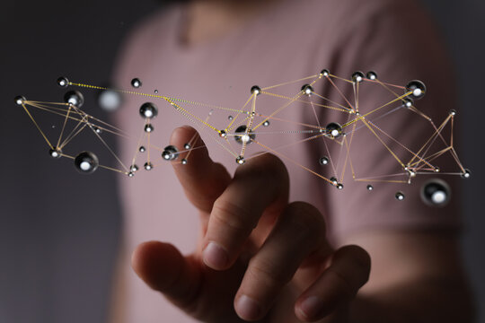 Close-up of a hand interacting with a 3D network, representing digital technology, connection, and global infor - Powered by Adobe