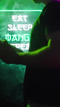 Person reading manga in front of futuristic neon signs Eat Sleep Manga Repeat