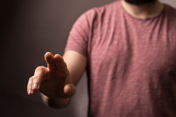 Close-up of a man's hand gesturing, possibly touching or pointing. Concept of direction, choosing, or interactio