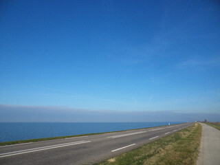Road and Blue sky with sea. Minimalist view. Nature backdrop. Beautiful natural flyer, card design. Nature Template for presentation or product 
