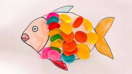 Creativity in the form of colorful fish with bright scales made from colored paper pieces