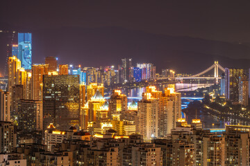 Naklejka premium Illuminated Cityscape with Skyscrapers and Bridges at Night