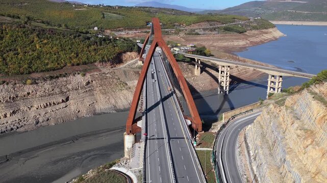 Aerial video of the A1 motorway crossing the Drin Valley near Kuk&euml;s, featuring the new Kuk&euml;s Bridge and surrounding autumn landscapes.