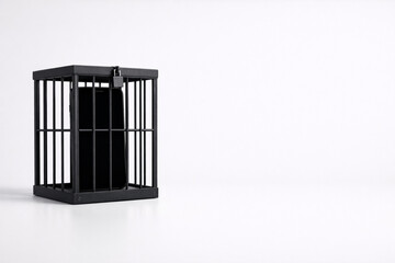 Smartphone addiction concept with a phone locked in a black cage on white background