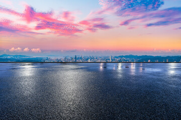 Empty asphalt road and city skyline with modern buildings at sunset in Shenzhen