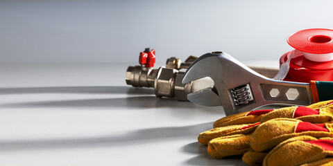 plumbing tools and equipment on grey background with place for text.