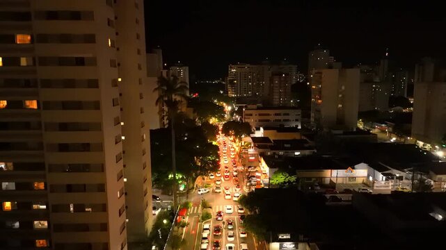 night aerial view of downtown Sao Jose dos Campos with bright lights over a busy street 