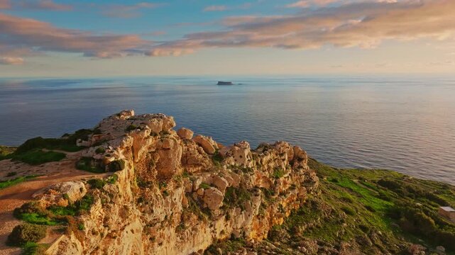 Drone view of countryside, rocks, hills. Famous Dingli cliffs, sunset spot. Mediterranean sea, Maltese island