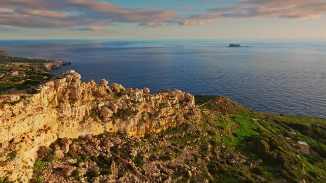Drone view of countryside, rocks, hills. Dingli cliffs, sunset spot. Mediterranean sea, Malta