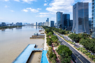 Urban Riverfront with Modern Skyscrapers and Blue Water