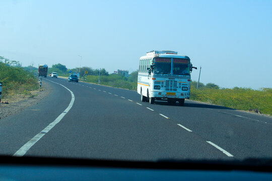 Barmer, Rajasthan, India - December 21, 2025: Public passenger bus moving on a national highway in rural Rajasthan, India.