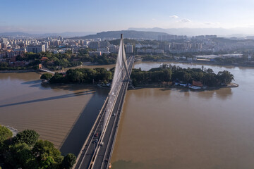 Aerial View of Modern Cable-Stayed Bridge Over River