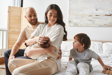 Joyful moments shared among family at home with new baby and siblings in warm embrace