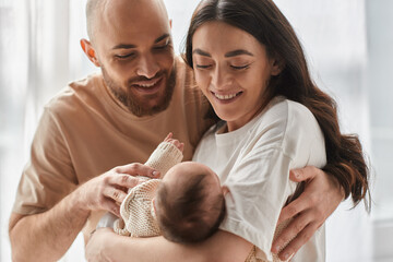 Joyful family bonding moment with a newborn in a cozy living space