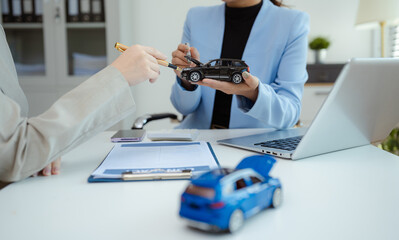 Female signing car insurance document or lease. Writing signature on contract or agreement. Buying or selling new or guarantee.